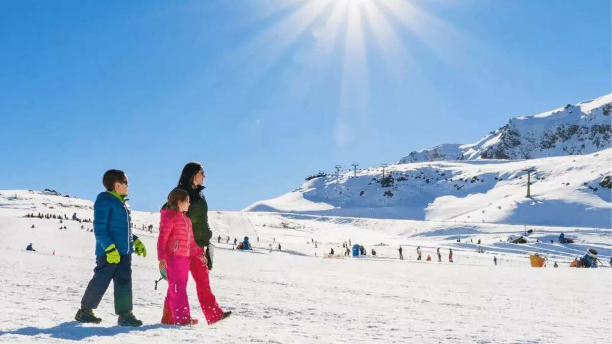 Family in the snow at a mountain resort (reference image)